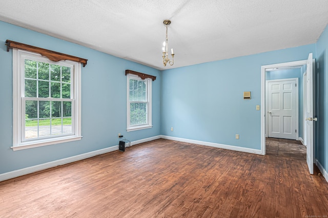 29 Daniels Rd, East Haddam, CT 06423 - spare room featuring wood finished floors, a chandelier, baseboards, and a textured ceiling