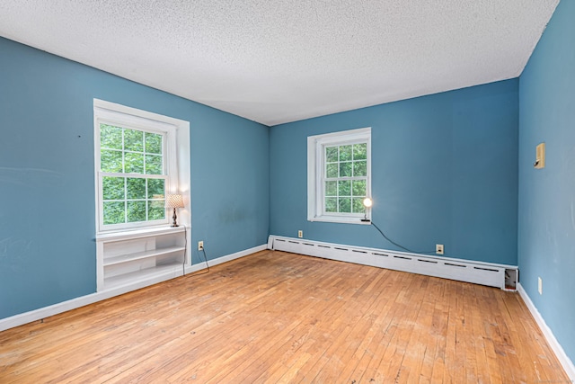 29 Daniels Rd, East Haddam, CT 06423 - spare room with hardwood / wood-style floors, a textured ceiling, plenty of natural light, a baseboard heating unit, and baseboards