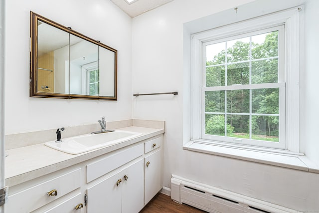 29 Daniels Rd, East Haddam, CT 06423 - bathroom featuring a baseboard heating unit, healthy amount of natural light, vanity, and wood finished floors