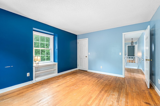 29 Daniels Rd, East Haddam, CT 06423 - unfurnished room featuring hardwood / wood-style flooring, a textured ceiling, and baseboards