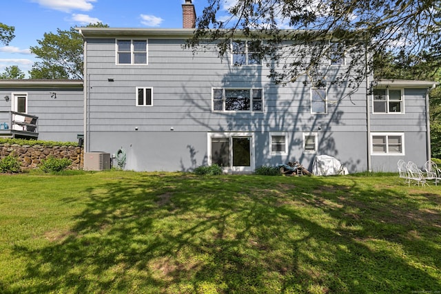 403 Bethmour Rd, Bethany, CT 06524 - rear view of house featuring a chimney, a lawn, ac unit, and stucco siding