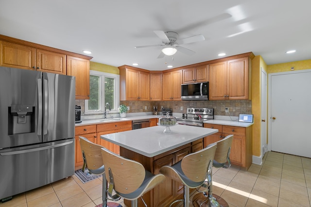 403 Bethmour Rd, Bethany, CT 06524 - kitchen featuring appliances with stainless steel finishes, a sink, light countertops, tasteful backsplash, and a ceiling fan