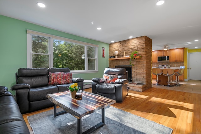 403 Bethmour Rd, Bethany, CT 06524 - living room with baseboard heating, light wood-style floors, recessed lighting, a fireplace, and ceiling fan