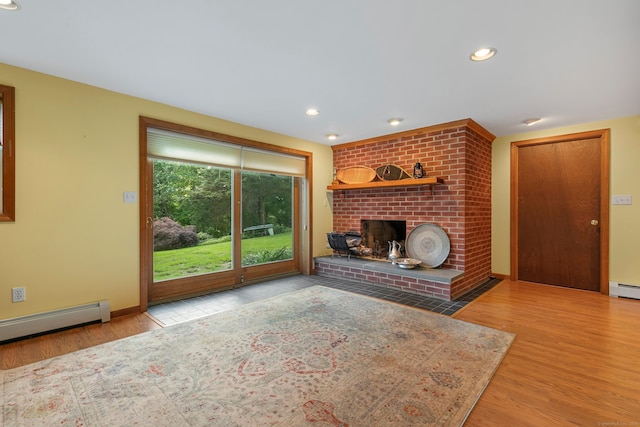 403 Bethmour Rd, Bethany, CT 06524 - unfurnished living room featuring wood finished floors, a baseboard heating unit, a brick fireplace, recessed lighting, and baseboards