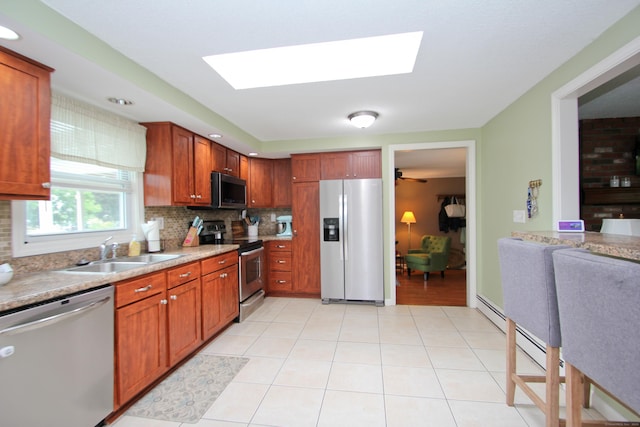 1 Deerfield Rd, Enfield, CT 06010 - kitchen featuring stainless steel appliances, a skylight, and backsplash