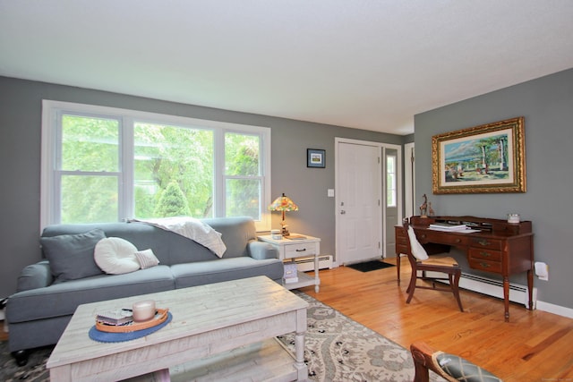 1 Deerfield Rd, Enfield, CT 06010 - living room with a baseboard heating unit and light wood-style flooring