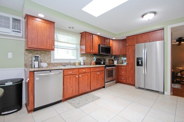 1 Deerfield Rd, Enfield, CT 06010 - kitchen featuring appliances with stainless steel finishes, backsplash, brown cabinets, recessed lighting, and wainscoting