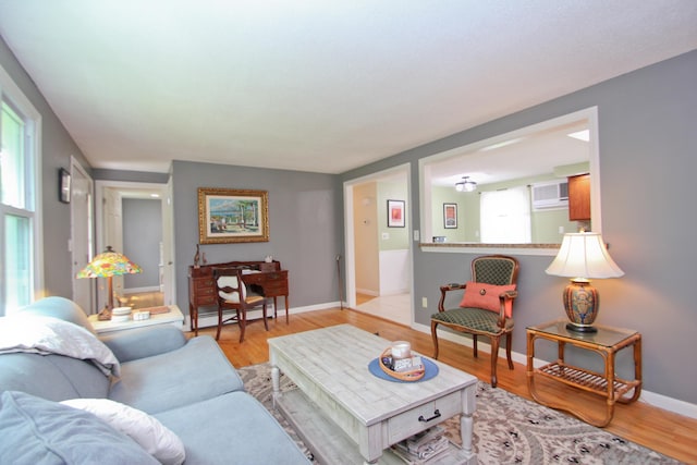 1 Deerfield Rd, Enfield, CT 06010 - living area featuring light wood finished floors and a baseboard heating unit