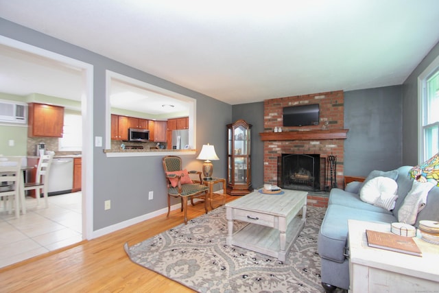 1 Deerfield Rd, Enfield, CT 06010 - living area with a fireplace and light wood-style flooring