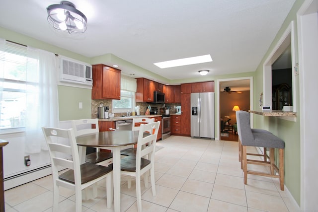 1 Deerfield Rd, Enfield, CT 06010 - dining space featuring a baseboard heating unit, a wall unit AC, light tile patterned flooring, and a skylight