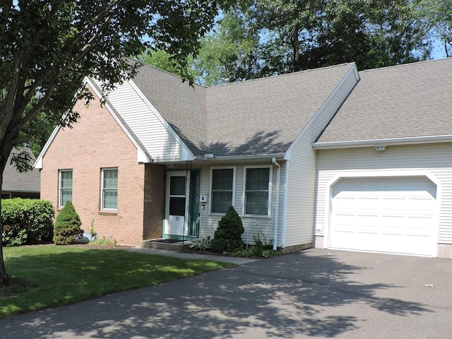 33 Shares Ln Unit 33, South Windsor, CT 06074 - view of front of property featuring asphalt driveway, a garage, brick siding, a front yard, and roof with shingles