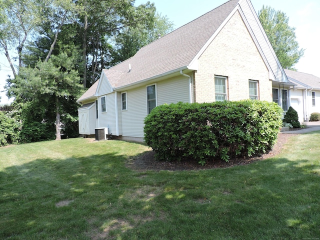 33 Shares Ln Unit 33, South Windsor, CT 06074 - view of side of property with a yard, a shingled roof, and brick siding