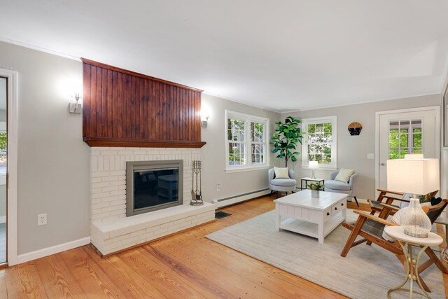 60 Indian Spring Rd, Woodstock, CT 06281 - living room featuring a baseboard radiator, light wood-style floors, plenty of natural light, and a fireplace