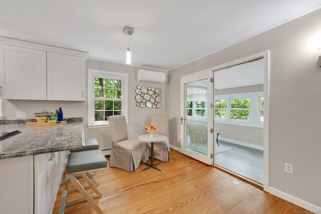 60 Indian Spring Rd, Woodstock, CT 06281 - living area featuring a wall mounted air conditioner, light wood finished floors, baseboards, a baseboard heating unit, and ornamental molding
