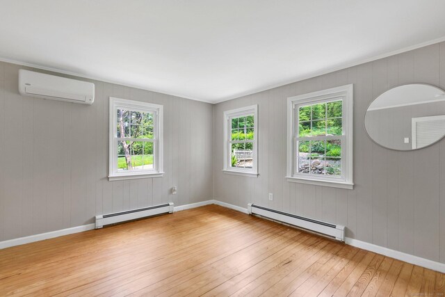 60 Indian Spring Rd, Woodstock, CT 06281 - spare room with a baseboard heating unit, an AC wall unit, wood-type flooring, and healthy amount of natural light