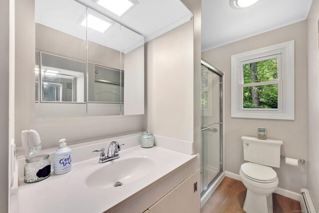 60 Indian Spring Rd, Woodstock, CT 06281 - bathroom with a baseboard heating unit, toilet, wood finished floors, vanity, and a stall shower