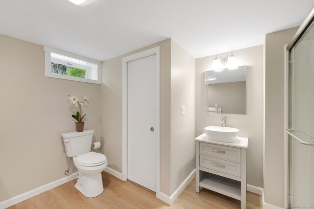 60 Indian Spring Rd, Woodstock, CT 06281 - bathroom with vanity, wood finished floors, toilet, and baseboards