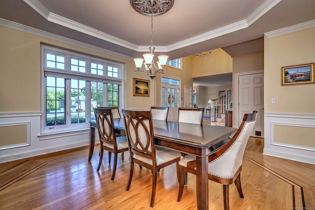 55 Riding Ridge Rd, Monroe, CT 06468 - dining space with a chandelier, light wood finished floors, crown molding, stairs, and wainscoting