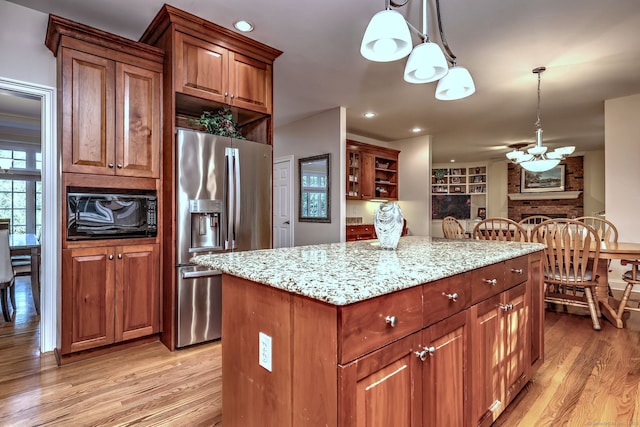 55 Riding Ridge Rd, Monroe, CT 06468 - kitchen with stainless steel fridge with ice dispenser, light wood finished floors, a kitchen island, light stone counters, and decorative light fixtures