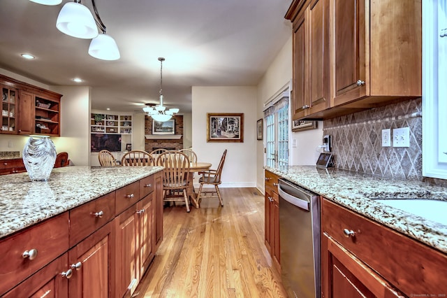 55 Riding Ridge Rd, Monroe, CT 06468 - kitchen with stainless steel dishwasher, light wood-style flooring, pendant lighting, ceiling fan, and light stone counters