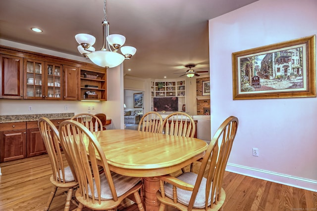55 Riding Ridge Rd, Monroe, CT 06468 - dining space with a chandelier, ceiling fan, light wood finished floors, built in features, and recessed lighting