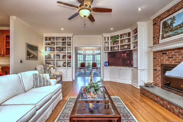 55 Riding Ridge Rd, Monroe, CT 06468 - living room featuring a fireplace, light wood-style floors, a ceiling fan, built in shelves, and recessed lighting
