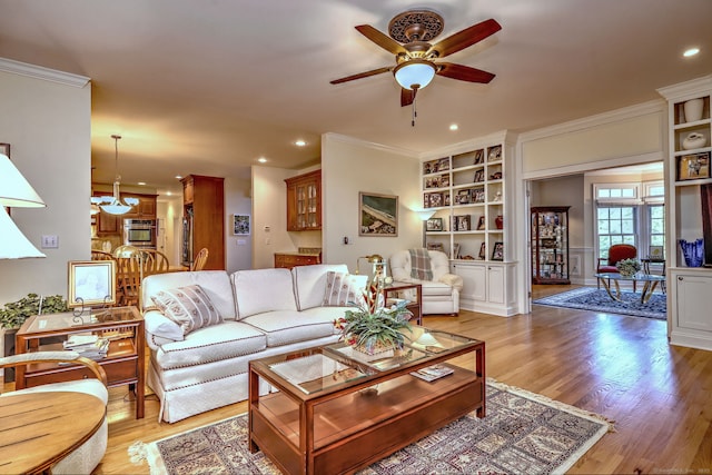 55 Riding Ridge Rd, Monroe, CT 06468 - living area featuring a ceiling fan, ornamental molding, light wood-style floors, recessed lighting, and a chandelier
