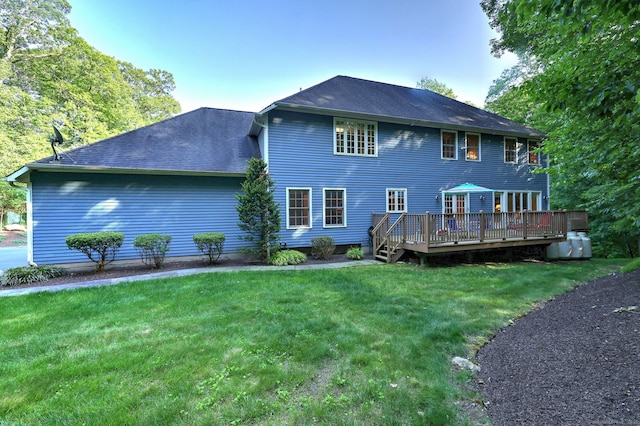55 Riding Ridge Rd, Monroe, CT 06468 - back of property featuring a deck, a lawn, and a shingled roof