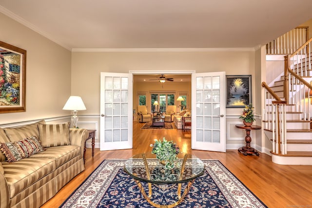 55 Riding Ridge Rd, Monroe, CT 06468 - living area with wood finished floors, stairway, ornamental molding, a ceiling fan, and wainscoting
