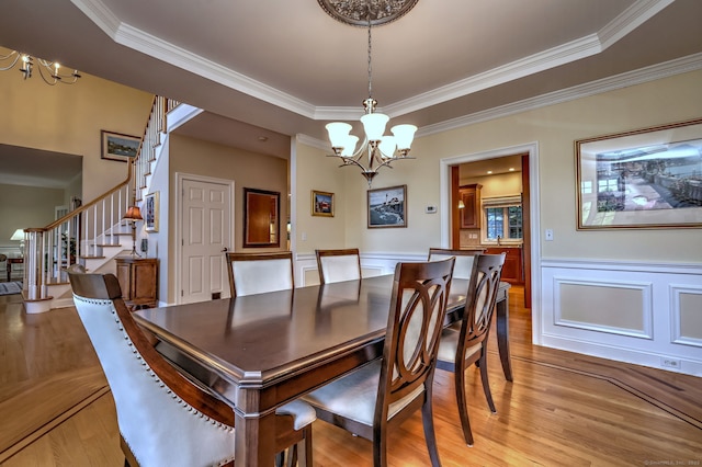 55 Riding Ridge Rd, Monroe, CT 06468 - dining space featuring a chandelier, stairs, light wood-type flooring, crown molding, and wainscoting