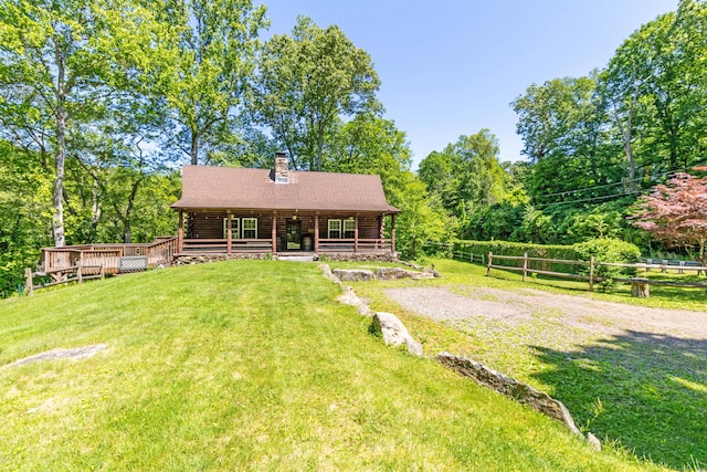 112 Edstrom Rd, Marlborough, CT 06447 - back of property with log siding, a chimney, covered porch, and view of wooded area