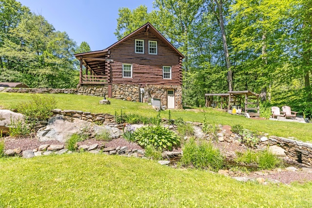 112 Edstrom Rd, Marlborough, CT 06447 - view of home's exterior with log siding, a yard, an outdoor fire pit, and stone siding
