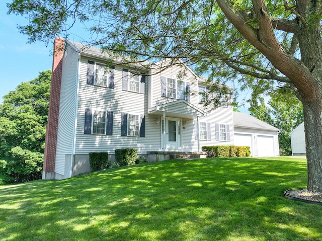 26 Reno Dr, Middletown, CT 06457 - view of front of house with a chimney, a front lawn, and a detached garage