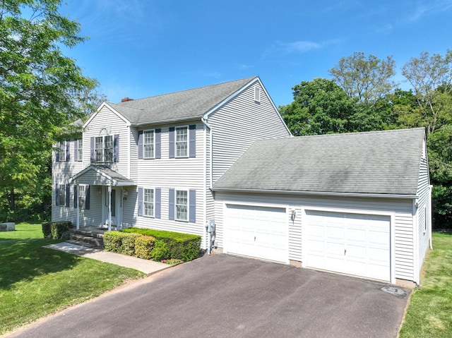 26 Reno Dr, Middletown, CT 06457 - colonial inspired home featuring a garage, asphalt driveway, a chimney, and roof with shingles