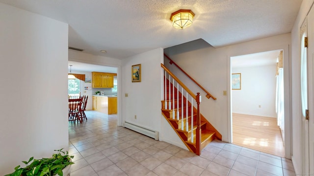 26 Reno Dr, Middletown, CT 06457 - stairs featuring baseboard heating, tile patterned flooring, and a textured ceiling