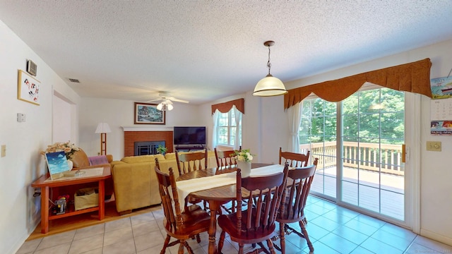 26 Reno Dr, Middletown, CT 06457 - dining space with a ceiling fan, a fireplace, a textured ceiling, and light tile patterned floors