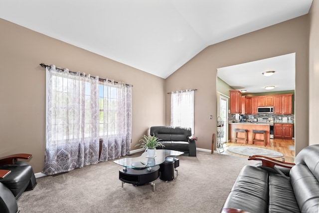 280 Ridgefield Ave, Waterbury, CT 06705 - living room with vaulted ceiling, plenty of natural light, baseboards, and light colored carpet
