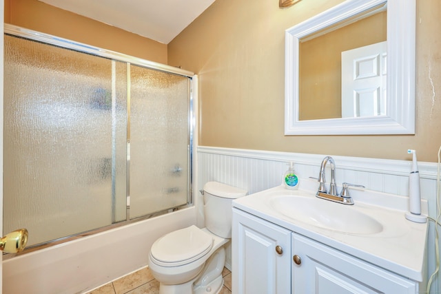 280 Ridgefield Ave, Waterbury, CT 06705 - full bath with toilet, wainscoting, vanity, bath / shower combo with glass door, and tile patterned floors