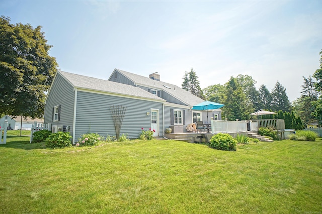 49 Hintz Dr, Wallingford, CT 06492 - back of property featuring a deck, a yard, roof with shingles, and a chimney