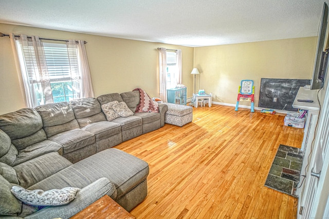 49 Hintz Dr, Wallingford, CT 06492 - living room with wood finished floors, baseboards, and a textured ceiling