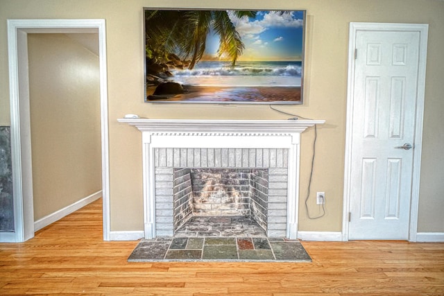 49 Hintz Dr, Wallingford, CT 06492 - detailed view of a fireplace, wood finished floors, and baseboards