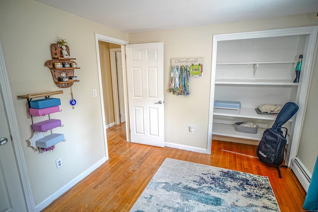 49 Hintz Dr, Wallingford, CT 06492 - bedroom with wood finished floors, baseboards, a closet, and baseboard heating