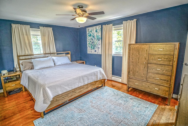 49 Hintz Dr, Wallingford, CT 06492 - bedroom featuring wood finished floors, a baseboard heating unit, a ceiling fan, and baseboards