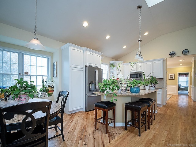 3 Timberland Way Unit 3, Beacon Falls, CT 06403 - kitchen featuring stainless steel appliances, white cabinets, hanging light fixtures, light wood-style floors, and lofted ceiling