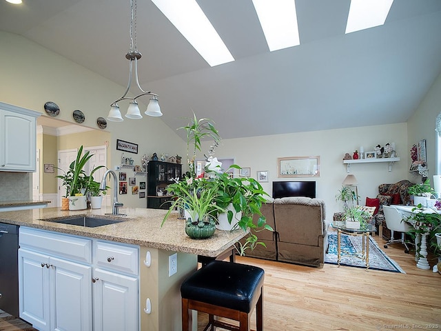 3 Timberland Way Unit 3, Beacon Falls, CT 06403 - kitchen featuring a sink, vaulted ceiling, light wood finished floors, white cabinets, and a skylight