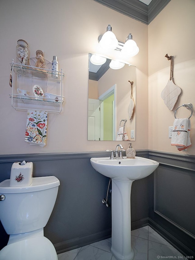 3 Timberland Way Unit 3, Beacon Falls, CT 06403 - half bathroom featuring ornamental molding, marble look tile flooring, toilet, a wainscoted wall, and a sink