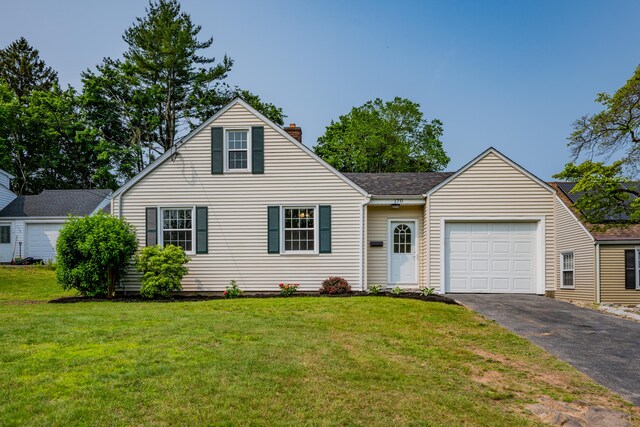 170 Morningside Dr E, Bristol, CT 06010 - view of front facade with asphalt driveway, a chimney, an attached garage, and a front lawn