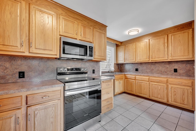170 Morningside Dr E, Bristol, CT 06010 - kitchen featuring appliances with stainless steel finishes, light brown cabinetry, light tile patterned floors, backsplash, and light countertops
