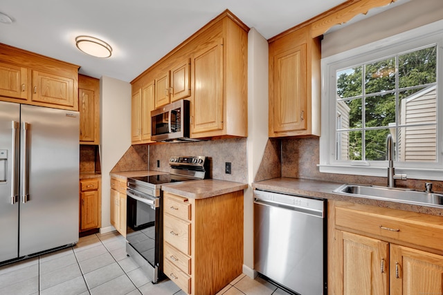 170 Morningside Dr E, Bristol, CT 06010 - kitchen with stainless steel appliances, a sink, decorative backsplash, light tile patterned floors, and light brown cabinets