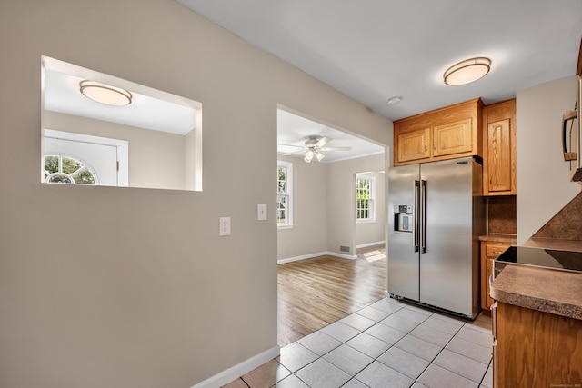 170 Morningside Dr E, Bristol, CT 06010 - kitchen with high end fridge, baseboards, light tile patterned flooring, and backsplash